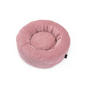 Vogelperspektive auf das runde Katzenbett aus rosa Cordstoff