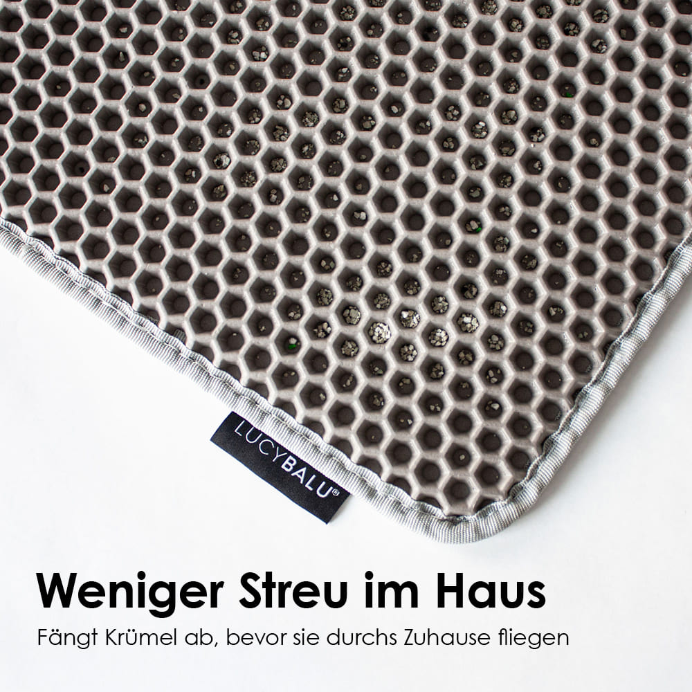 nahaufnahme von katzen streu matte mit text: "weniger streu im haus"